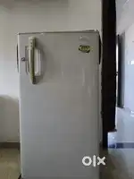 Videocon fridge with a cover and stand.
