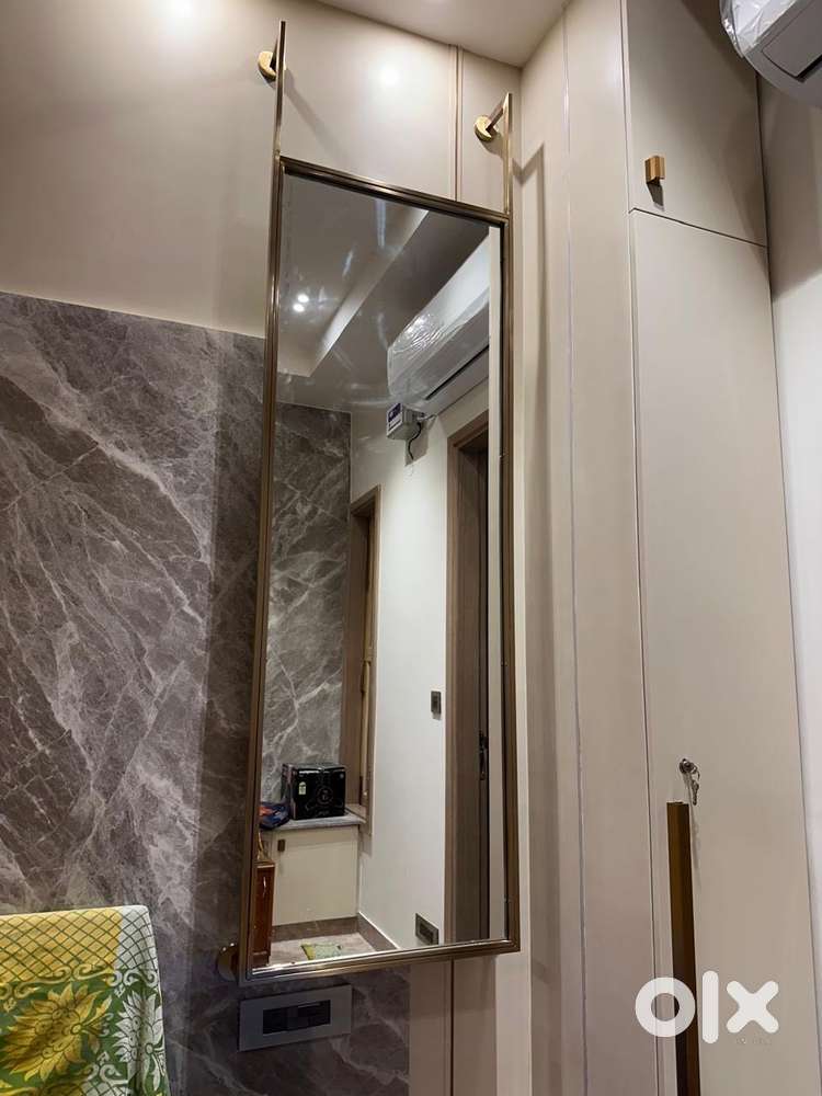 Mirror with brushed gold metal plate