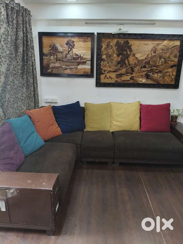 Brown wooden sofa .