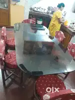 6 sitter glass topped wooden dinning table with 6 wooden chairs