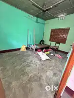 1 RK with bed,chair,fan and a kitchen shelf