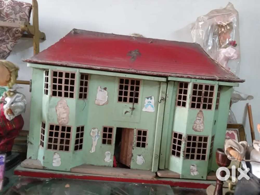 An antique dolls' house and  45 years old doll, purchased from France.