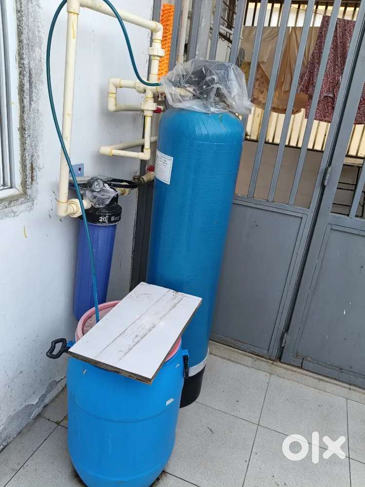 Water softener treatment device