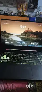 ASUS F-15 Gaming Laptop with gaming mouse and charger