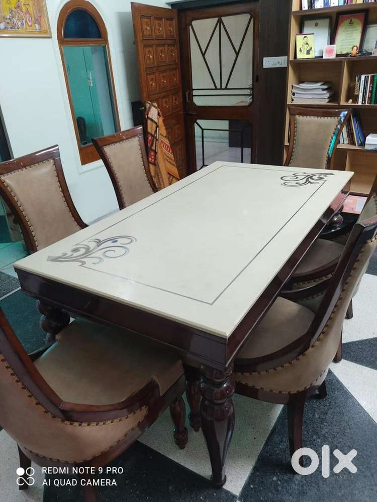 Wooden Dinning table with Granite top and six set of comfor chairs.