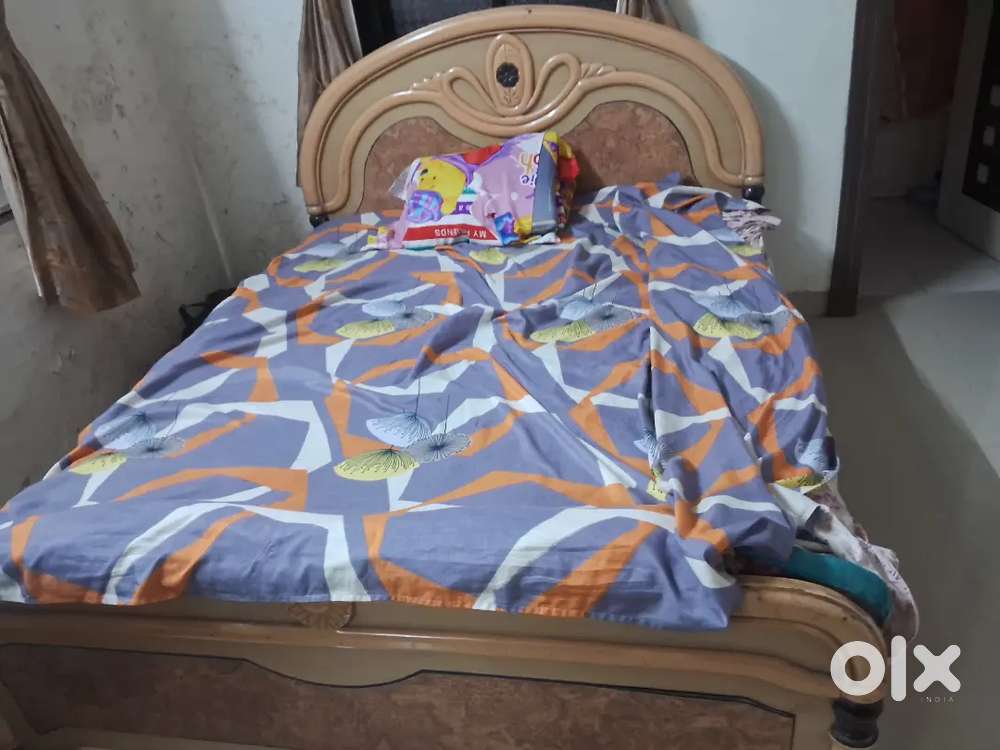 Wooden bed with mattress