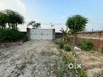 Gated property with 1 big room and all around walls for sale.