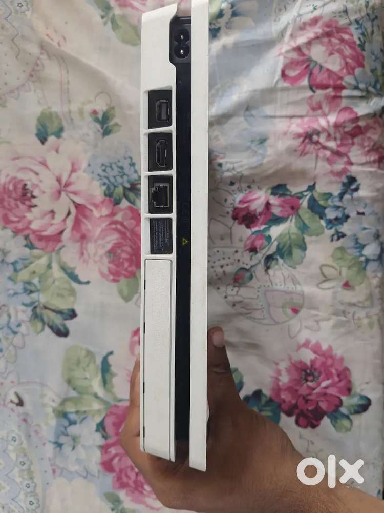 White PS4 slim, 1TB variant for sale.