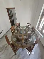 Teak wood dining table with glass top.