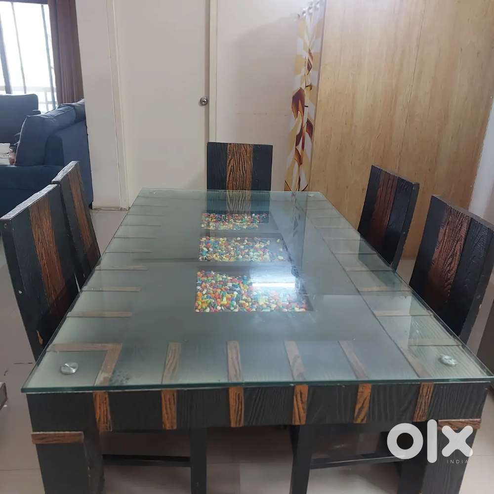 Wooden dinning table with glass top and six chairs