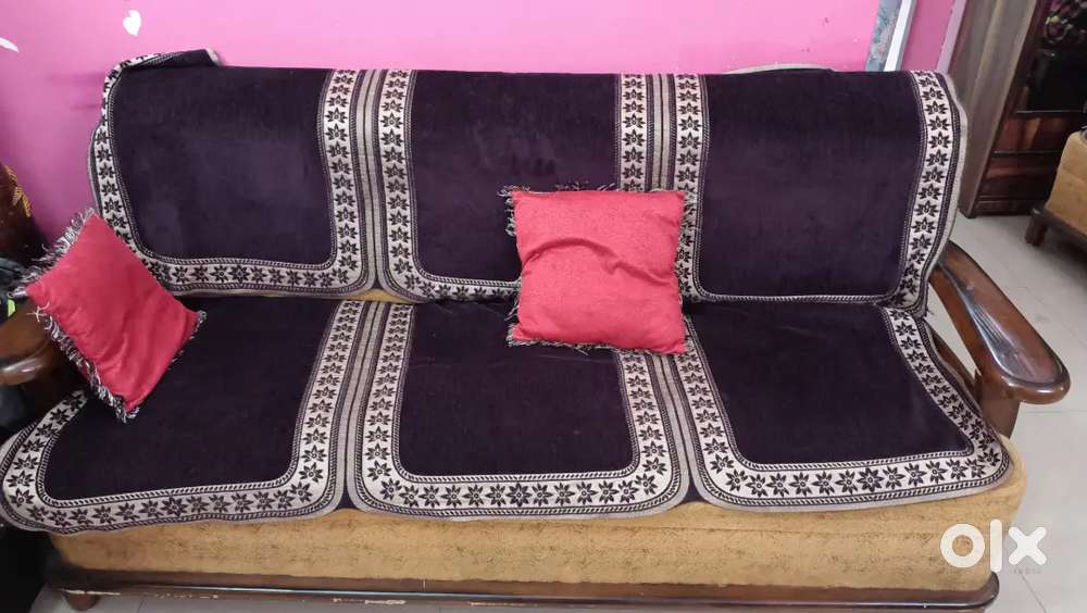 Gently used 5 seater wooden sofa along with cover and cushion for sale
