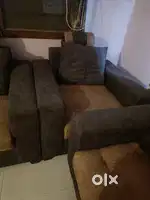 5 seater sofa set with wooden table glass on top.