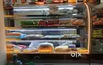 Curved glass Display counter for sweets and other bakery products.