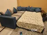 6 seater Sofa cum Bed with centre table and 2 ottomans