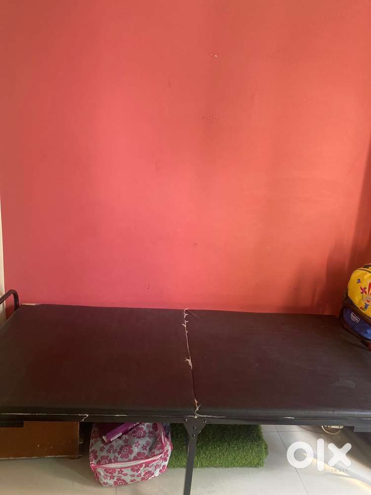 Single foldable bed with attached mattress