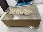 Brown wooden center table glass top