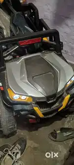 A child playing cars with remote and self driving battery vehicle