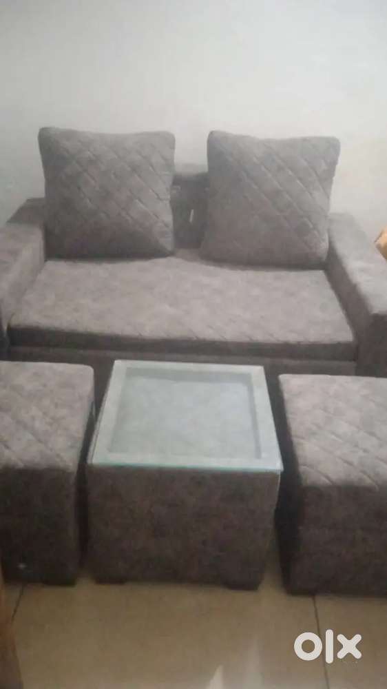 Sofa cum bed + glass Centre table & 2 ottoman stools +2 big cushions