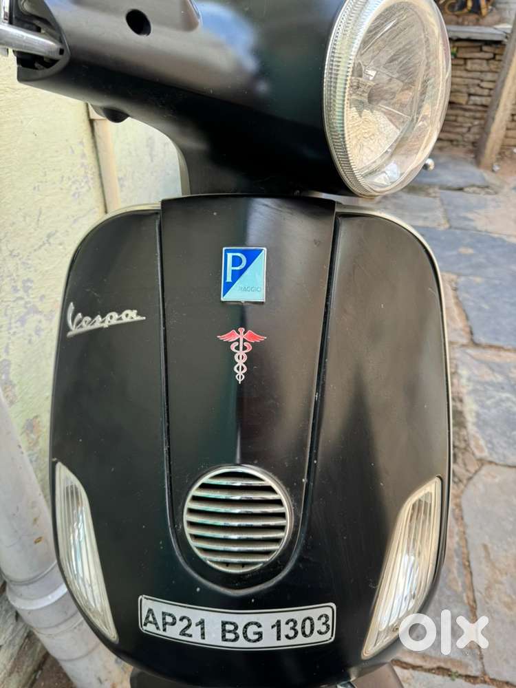 Black vespa driven by doctor neat maintained