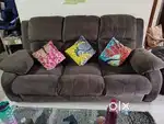 Recliner style sofa with coffee table for sale.