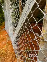 Chain link ,barbed wire and slab wall fence