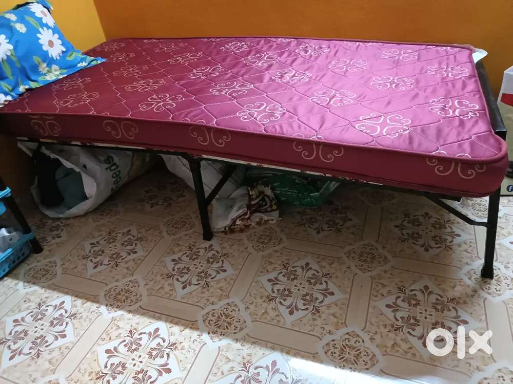 Folding bed with mattress