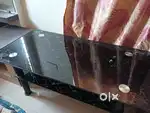 Glass top black center table