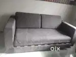 Sofa cum bed and center table