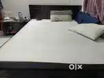 Queen size bed with mattress and pillow