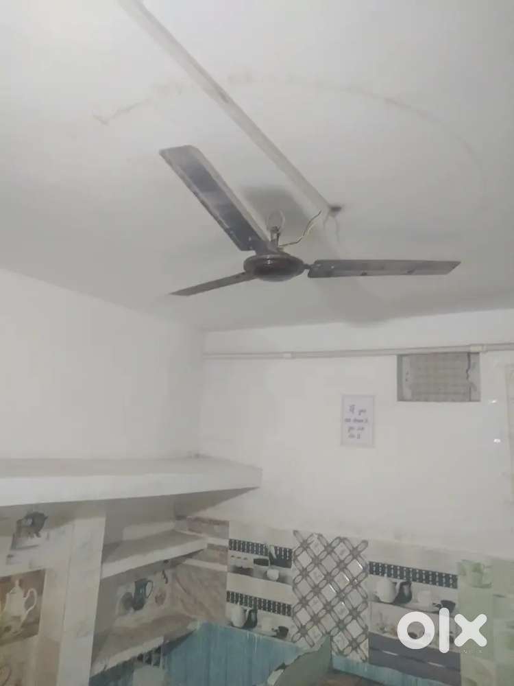 ,1room kitchen with bed fan bulb chair