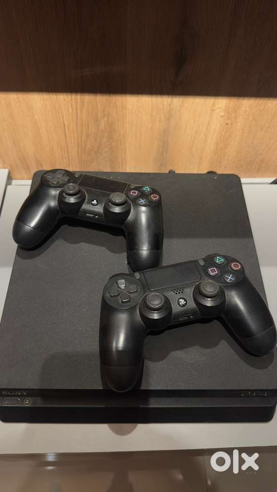 PS4 Slim 1TB with OG 2 Dual shock 4 controllers and some games