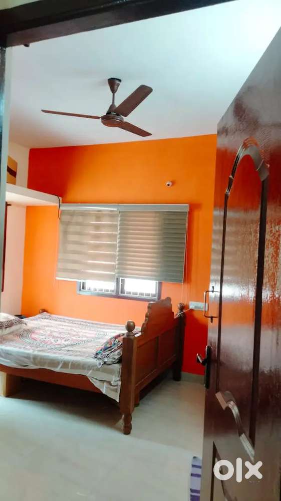 Spacious room with attached balcony and bath available for rent.