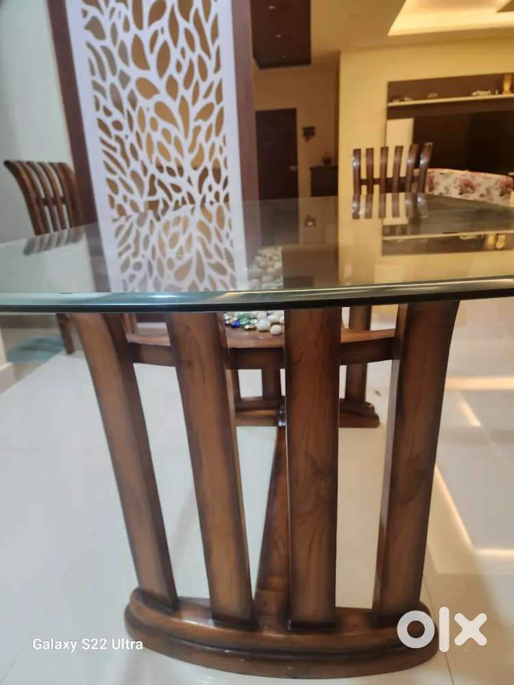 Dinning table with chairs 4 seater made with teak wood on glass top.