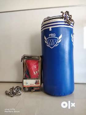 Less than a year old punching bag with hanging chain and a pair of usi boxing gloves are for sale as...