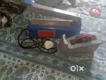 Sealing machine and tape dispenser