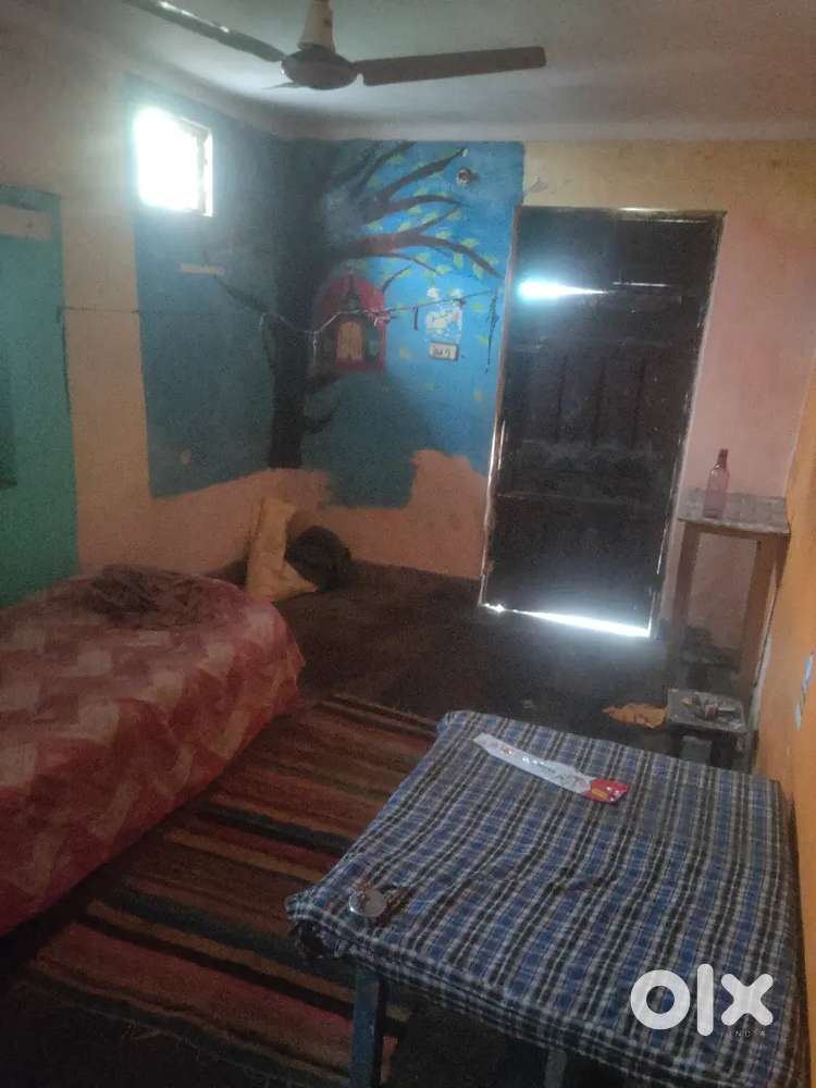 Single room with bed bedding fan table