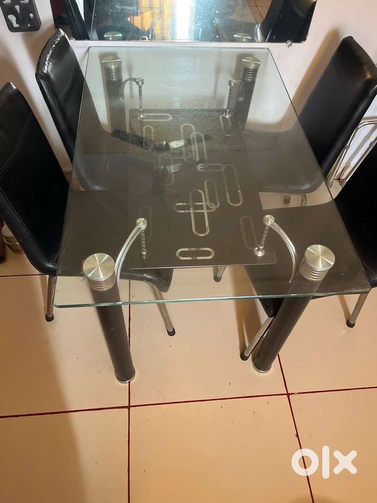 Four seater glass top dining table.