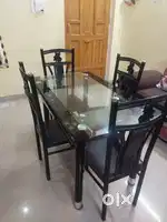 Glass dinning table with four chairs well maintained ,good condition