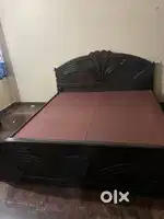 King sized Bed with 4 set storage facilities.
