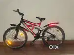 Single speed cycle with front and back suspension.