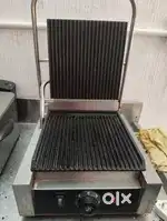 Kitchen equipment ( fridge, table, oven, grill sandwich)