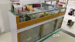 Wooden counter with glass top and glass shelves