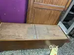 wooden diwan bed with integrated storage.