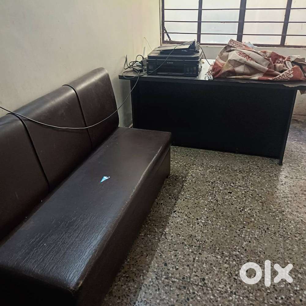 There is a computer table in the office which is in the office. Suitab