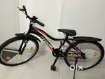 Matte black and orange, single speed 26T less used cycle