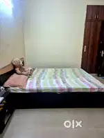 Bed with mattress and side table