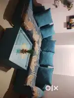 Beautiful L shaped sofa with glass table