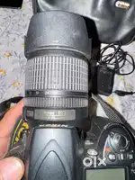 Nikon D 90 with battery, charger, and leather bag