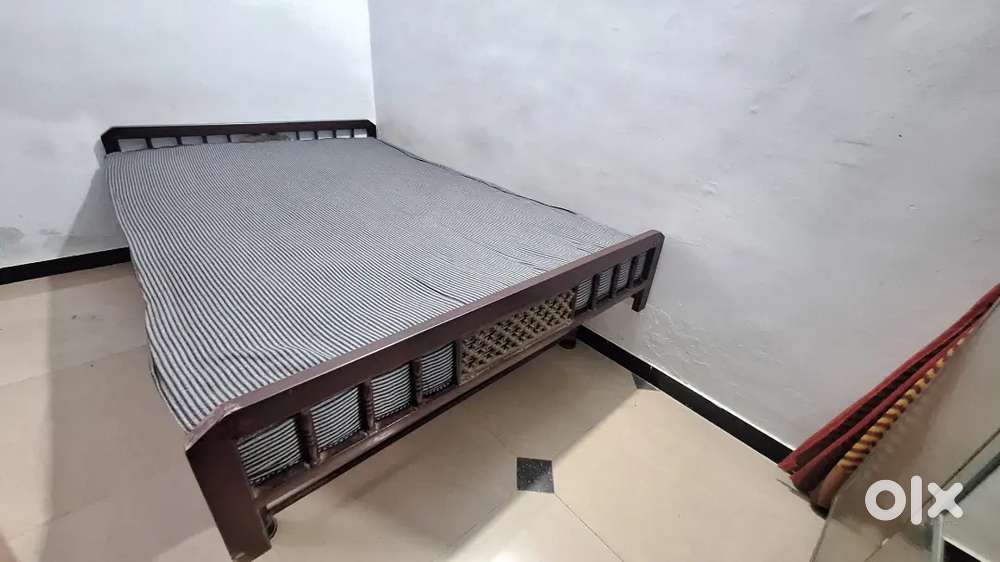 Bed with mattress and mattress cover.