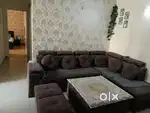 L shape 7 seater sofa with glass center table and 2 puffs